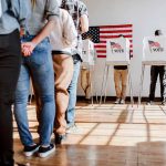 People in line at voting booths.