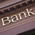 "Bank sign on building facade."