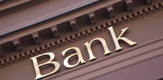 "Bank sign on building facade."