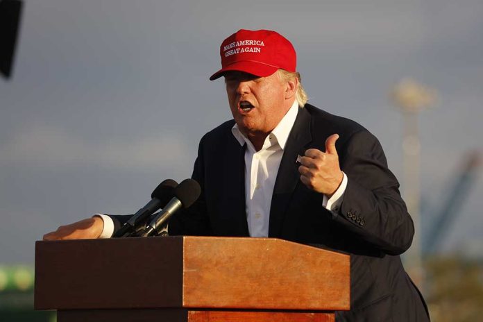 Person speaking at a podium wearing a red hat.