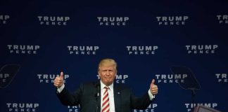 Man giving thumbs up at Trump Pence rally.