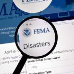 Magnifying glass over FEMA Disasters webpage.