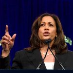 Woman speaking passionately at a podium.