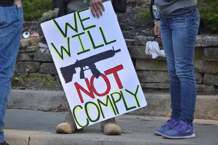 Protest sign reads: "We Will Not Comply".