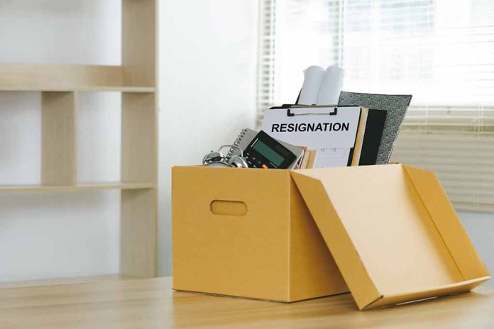 Yellow box with resignation notice on an office desk.