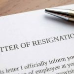 Resignation letter with a pen on top.