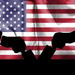 Silhouette handshake over United States flag background.