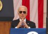 Man in sunglasses in front of American flag.