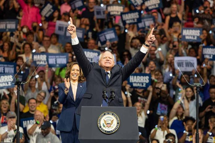 Man and woman celebrating on stage with supporters.