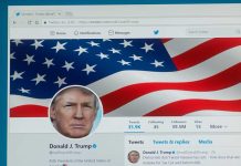 Twitter profile page with American flag banner.