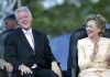 Two people sitting and laughing joyfully together.