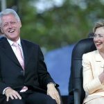 Two people sitting and laughing joyfully together.