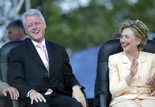 Two people sitting and laughing joyfully together.