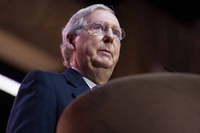 Man speaking at a podium, wearing glasses.