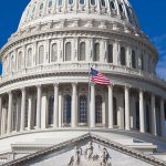 U.S. Capitol dome with American flag flying.