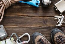 Hiking gear on wooden surface with boots visible