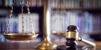 Gavel and scales of justice on desk.