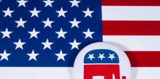 Republican elephant button on American flag background.