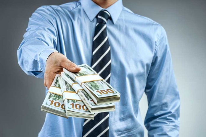 Person handing over a stack of money.