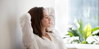 Woman relaxing on a couch near plants