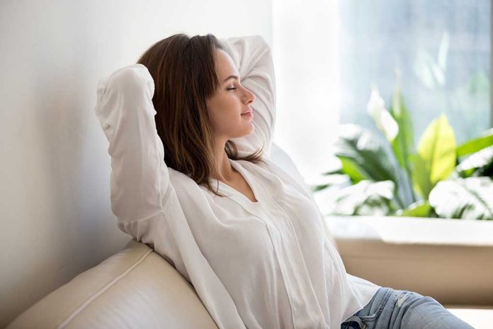 Woman relaxing on a couch near plants