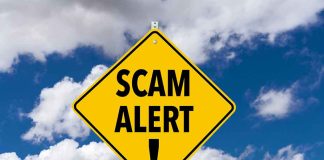 Yellow diamond sign saying scam alert warning