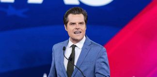 Person speaking at podium with CPAC backdrop.