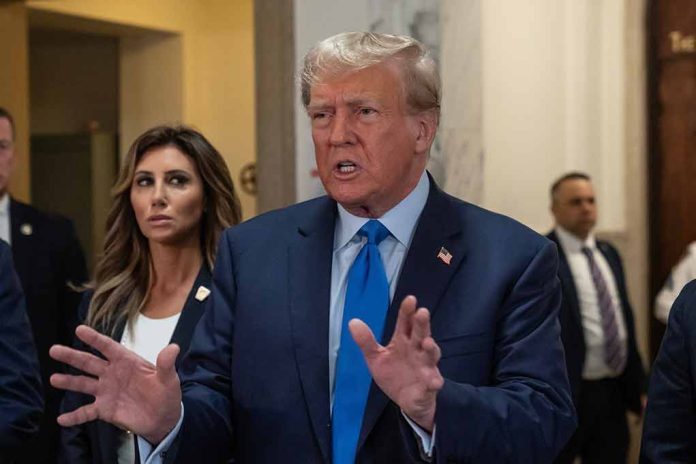 Man speaking with gestures, woman and men in background.