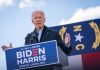 Man speaking at podium during outdoor event