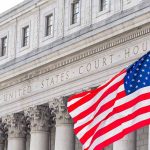 United States Courthouse with American flag in front.