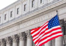 United States Courthouse with American flag in front.