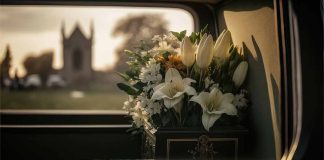 White flowers in a car with blurred background.