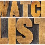 "Watch List" in large wooden block letters.