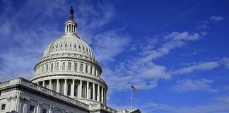 US Capitol building under a blue sky.