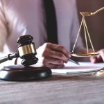 Gavel and scales of justice on desk.