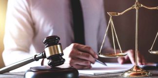 Gavel and scales of justice on desk.