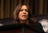 Woman speaking at podium with intense expression.