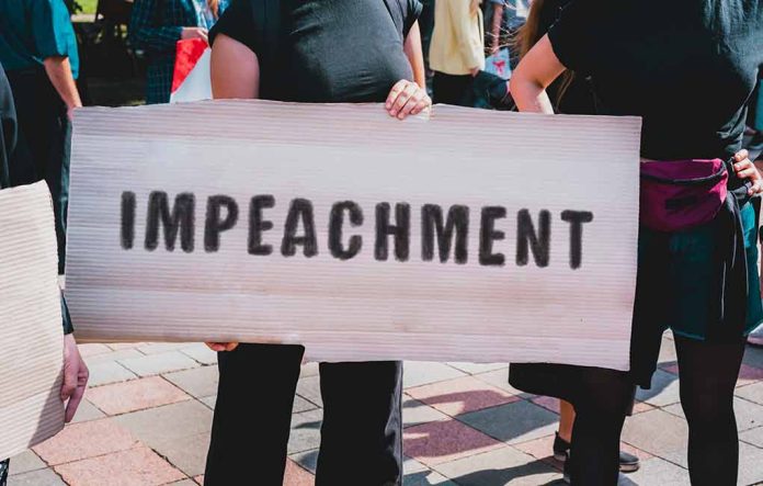 Person holding an "Impeachment" sign at protest.