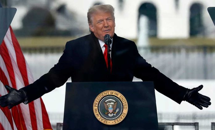 Person speaking at a podium with microphones.