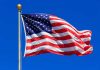 United States flag waving against blue sky