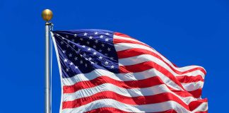 United States flag waving against blue sky