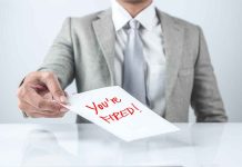 Person handing a paper with "You're Fired!" text.