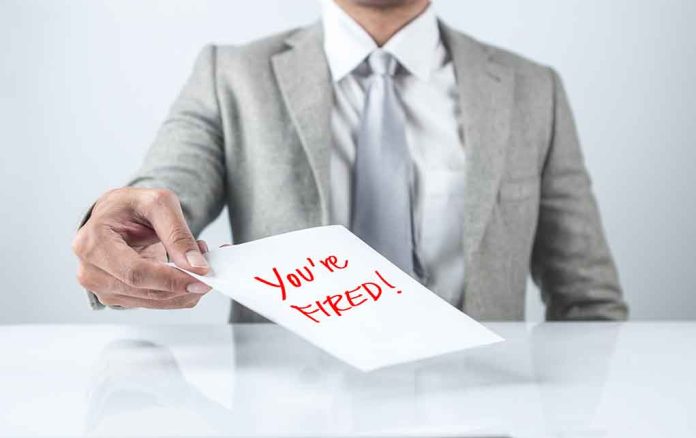 Person handing a paper with "You're Fired!" text.