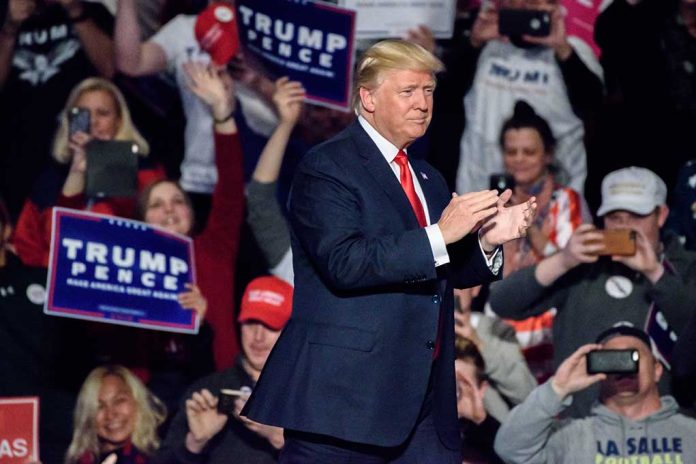 Man clapping at a crowded political rally event