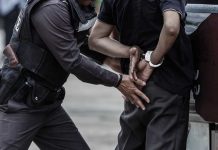 Police officer arresting and handcuffing a person