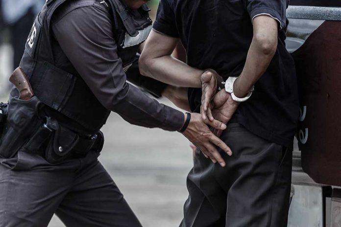 Police officer arresting and handcuffing a person