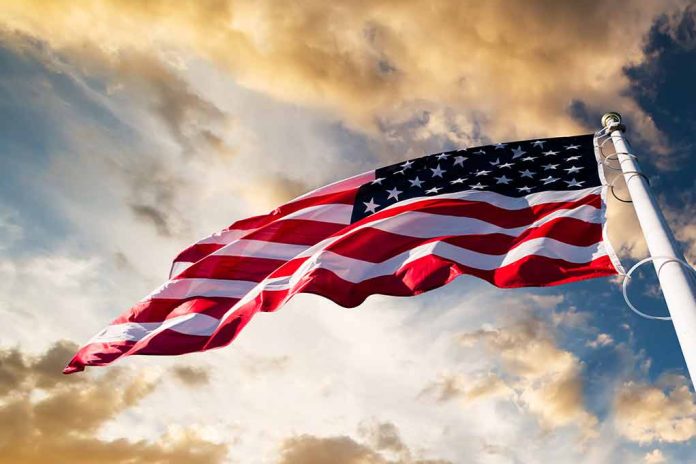 American flag waving against a dramatic cloudy sky