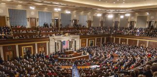 Audience in a large hall with central podium