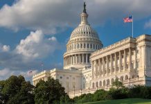 United States Capitol building with American flags nearby