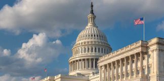 United States Capitol building with American flags nearby